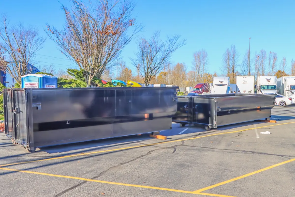 Professional dumpster rental service with roll-off container on residential driveway in Halls